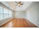 Spacious main bedroom with tray ceilings, a ceiling fan, and wood flooring at 104 Shadow Creek Ct, Fairburn, GA 30213
