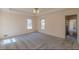 This spacious carpeted bedroom has lots of natural light and a doorway into another room at 110 Eastfield Ct, Mcdonough, GA 30252