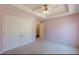 A large bedroom features a window, closet and attached doorway at 110 Eastfield Ct, Mcdonough, GA 30252