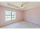 A bright bedroom with carpet, and large window offers views of the outdoors at 110 Eastfield Ct, Mcdonough, GA 30252