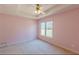 The bedroom features a tray ceiling with fan and light fixture, carpet, and a window at 110 Eastfield Ct, Mcdonough, GA 30252