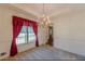 Cozy dining room with classic chandelier, neutral carpet, and backyard views at 110 Eastfield Ct, Mcdonough, GA 30252