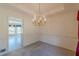 Dining room view showing breakfast area and large chandelier at 110 Eastfield Ct, Mcdonough, GA 30252