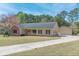 Ranch-style home featuring a two-car garage, a long driveway, and a well manicured lawn at 110 Eastfield Ct, Mcdonough, GA 30252