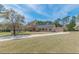 Ranch-style home featuring a two-car garage, a long driveway, and a well manicured lawn at 110 Eastfield Ct, Mcdonough, GA 30252