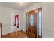 Inviting foyer with hardwood floors, paneled walls, and stained-glass front door at 110 Eastfield Ct, Mcdonough, GA 30252