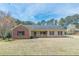 Charming single-story home featuring a brick facade, covered porch, and well-maintained lawn at 110 Eastfield Ct, Mcdonough, GA 30252