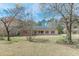 Inviting single-story home with mature trees providing shade and curb appeal at 110 Eastfield Ct, Mcdonough, GA 30252