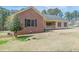 Well-maintained home featuring a brick accent wall, a covered front porch, and established landscaping at 110 Eastfield Ct, Mcdonough, GA 30252