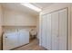 Functional laundry room with washer, dryer, sink, and ample storage at 110 Eastfield Ct, Mcdonough, GA 30252