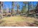 A grassy, fenced-in backyard bordered by mature trees and lush greenery offers a private outdoor space at 1584 Belva Ave, Decatur, GA 30032