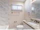 Well-lit bathroom featuring granite countertops and marble tile walls at 1584 Belva Ave, Decatur, GA 30032