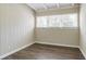 This bedroom includes three windows and new wood-look flooring at 1584 Belva Ave, Decatur, GA 30032