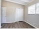 Bedroom featuring wood floors, window, and closet at 1584 Belva Ave, Decatur, GA 30032