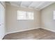 Bedroom with two windows, wood floors, and closet at 1584 Belva Ave, Decatur, GA 30032