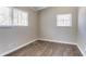 Bright bedroom featuring two windows and wood flooring at 1584 Belva Ave, Decatur, GA 30032