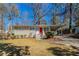 Charming ranch home featuring a brick facade, bright red front door, and covered carport at 1584 Belva Ave, Decatur, GA 30032