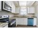 Modern kitchen with granite countertops, stainless steel appliances, and white cabinets at 1584 Belva Ave, Decatur, GA 30032