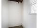 Utility room featuring white walls, laminate flooring, and a window at 1584 Belva Ave, Decatur, GA 30032