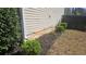 A view of the side yard with manicured landscaping near a wood fence at 5582 Windwood Rd, Atlanta, GA 30349