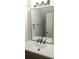 Bathroom featuring a large mirror, modern vanity, and neutral decor at 5582 Windwood Rd, Atlanta, GA 30349
