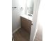 Modern bathroom featuring a stylish vanity with a golden mirror and hardwood floors at 5582 Windwood Rd, Atlanta, GA 30349