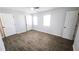 A bright bedroom with wood-look flooring and white doors at 5582 Windwood Rd, Atlanta, GA 30349
