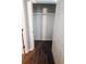Walk-in closet with built-in shelving and dark wood-look flooring at 5582 Windwood Rd, Atlanta, GA 30349