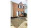 Two story brick home with a front yard and black shutters on the windows at 5582 Windwood Rd, Atlanta, GA 30349
