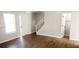 Open-concept living room showcasing wood-look floors, natural light, and a staircase at 5582 Windwood Rd, Atlanta, GA 30349