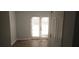Bright room showcasing neutral paint, wood-look floors, and glass doors to the outside at 5582 Windwood Rd, Atlanta, GA 30349
