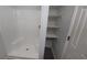 Bright bathroom with white shower and shelving at 5582 Windwood Rd, Atlanta, GA 30349