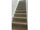 Wooden staircase with light risers and wooden steps adding style to the home at 5582 Windwood Rd, Atlanta, GA 30349