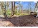 Large backyard with an expansive green space, partially fenced in, and a wooden deck area at 5916 Simone Dr, Stone Mountain, GA 30087