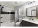 Charming bathroom featuring a shower-tub combo, vanity, and marble-look tile at 5916 Simone Dr, Stone Mountain, GA 30087