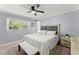 Cozy bedroom featuring a queen-sized bed, bench, and windows for natural light at 5916 Simone Dr, Stone Mountain, GA 30087