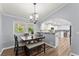 Cozy dining area with a stylish table set, complemented by natural light, seamlessly connected to the modern kitchen at 5916 Simone Dr, Stone Mountain, GA 30087