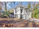 Side view of the house showing the driveway and garage and surrounding foliage at 5916 Simone Dr, Stone Mountain, GA 30087