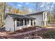 Charming two-story home with a white painted brick, black trim, and a well-maintained front yard at 5916 Simone Dr, Stone Mountain, GA 30087