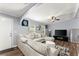 Bright living room featuring a plush sectional sofa, modern decor, and ample natural light from large windows at 5916 Simone Dr, Stone Mountain, GA 30087
