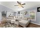 Living room features a plush sectional sofa, modern decor, and ample natural light from large windows at 5916 Simone Dr, Stone Mountain, GA 30087