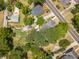 Aerial perspective of the property showcasing mature trees, a sprawling yard, and outbuildings at 1000 Nw Main St, Conyers, GA 30012