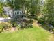 Expansive backyard featuring a lush lawn, mature trees, and a patio with seating at 1000 Nw Main St, Conyers, GA 30012