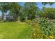 Expansive lawn with colorful flowerbeds, mature trees, and a charming home with a balcony at 1000 Nw Main St, Conyers, GA 30012