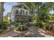 Two story home with back patio, garden, and tiered water fountain at 1000 Nw Main St, Conyers, GA 30012