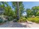 Beautifully landscaped backyard with brick patio and a variety of plants and greenery at 1000 Nw Main St, Conyers, GA 30012