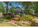 Backyard garden and lush landscaping with cozy bench seating area and elegant two-story home at 1000 Nw Main St, Conyers, GA 30012