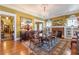 Dining room features a chandelier, fireplace, hardwood floors and large windows at 1000 Nw Main St, Conyers, GA 30012