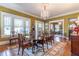 Traditional dining room with chandelier, windows, and hardwood floors at 1000 Nw Main St, Conyers, GA 30012