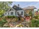 Quaint garden path leads to this charming home with an American flag, stone steps and flourishing plants at 1000 Nw Main St, Conyers, GA 30012